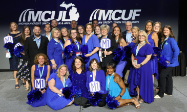 M1 team members celebrate achievement.